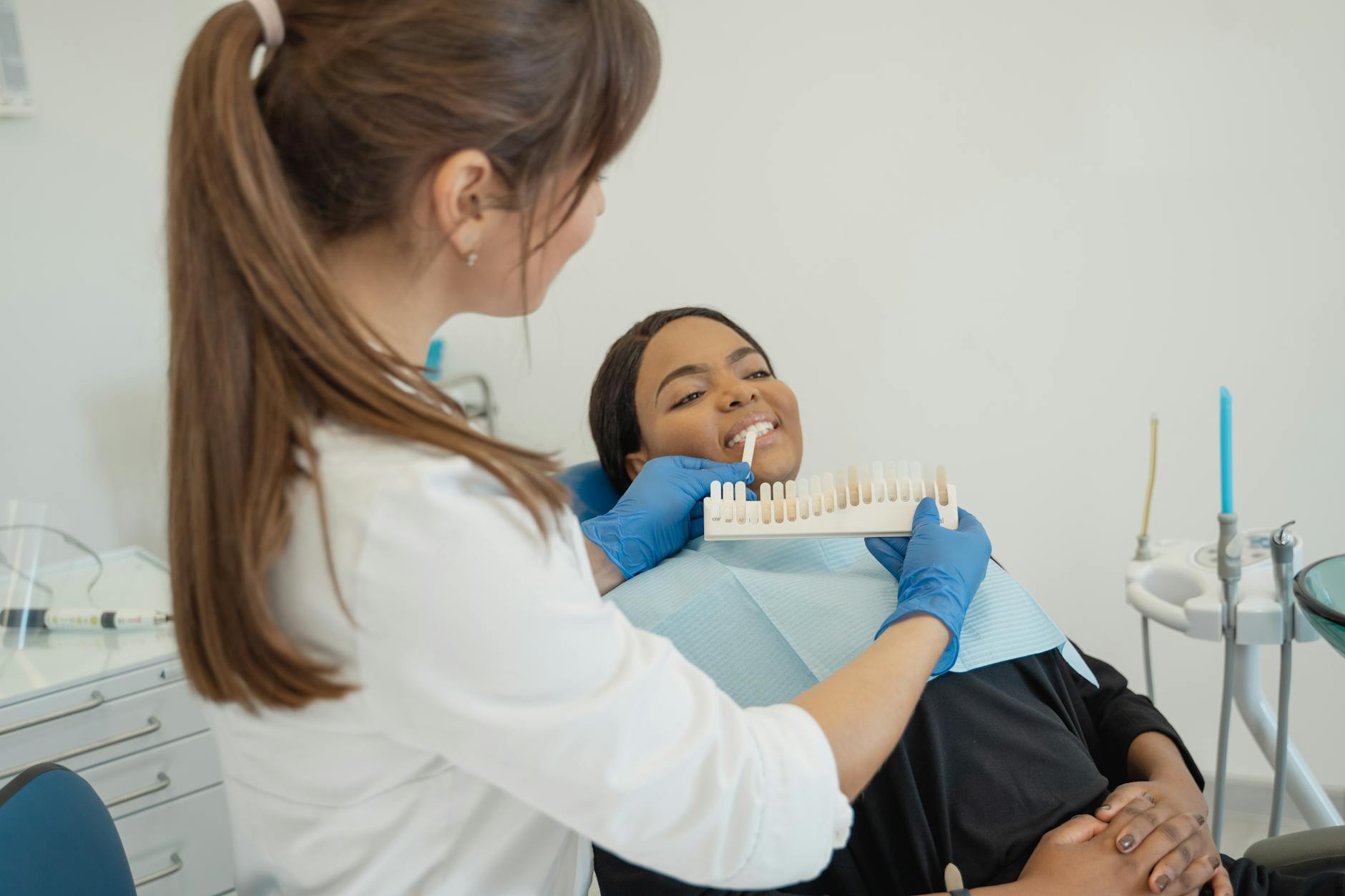 dentist holding a tooth shade guide